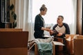 Moving day, new home, unpacking boxes. Happy couple in their new apartment is having fun with cardboard boxes. Cheerful Royalty Free Stock Photo