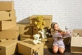 Moving in. Delivering service. Only necessary things. Playroom concept. Sweet home. Girl child relaxing after unpacking Royalty Free Stock Photo