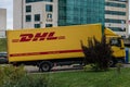 A moving DHL truck, courier service delivers parcels to customers, courier company , international express mail services. online