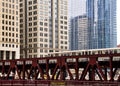 Moving elevated el train, part of Chicago`s iconic transit system, crosses Wells Street bridge over the Chicago River in the Loop Royalty Free Stock Photo