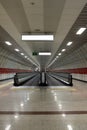 Moving escalator in subway station. Walkway with Blank billboard located in underground hall or subway for advertising, mockup con Royalty Free Stock Photo