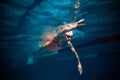 Moving fast. Competitive woman, professional female swimmer training in swimming pool indoor. Underwater view. Concept Royalty Free Stock Photo