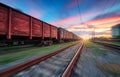 Moving freight train at sunset. Railroad and beautiful sky Royalty Free Stock Photo