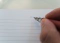 Moving hand with fountain pen and notebook