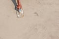 Moving hand and shadow of mason worker using steel trowel plastering aligns with cement floor.