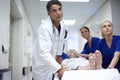 Moving her to the recovery theatre. A team of doctors pushing a patient down the hall. Royalty Free Stock Photo