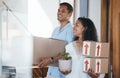 Moving, home and couple with boxes, smile and excited for growth, real estate and relationship. Partners, man and woman