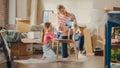 Moving in and Home Renovations: Happy Mother and Daughter Painting Vintage Furniture Chair for New Royalty Free Stock Photo
