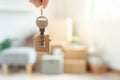 Moving house, relocation. Man hold key house keychain in new apartment. move in new home. Buy or rent real estate. flat tenancy,