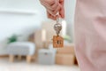 Moving house, relocation. Woman hold key house keychain in new apartment. move in new home. Buy or rent real estate. flat tenancy