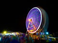 Moving light from ferris wheel at night Royalty Free Stock Photo