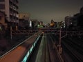 Moving motion scene of night train toward city center Royalty Free Stock Photo