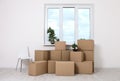 Moving into a new apartment. Move lots of cardboard boxes in an empty new apartment. Royalty Free Stock Photo