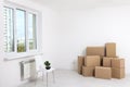 Moving into a new apartment. Move lots of cardboard boxes in an empty new apartment. Royalty Free Stock Photo