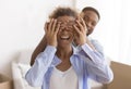 African American Man Covering Wife`s Eyes Before Showing Their Apartment