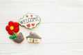 Moving in new house, Welcome home set. House, plant,heart, welcome sign cookies on white wood, flat lay with space for text. Dream