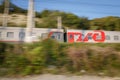 The moving passenger train of the Russian Railways, RZHD coming from Adler. Motion blur Royalty Free Stock Photo