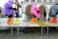 moving people with plastic leggings on the footbridge in Venice Royalty Free Stock Photo