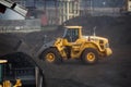 Moving piles of coal with a bulldozer Royalty Free Stock Photo