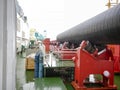 Moving the pipeline on rollers from the deck to the assembly workshop. Works on the installation of an underwater gas pipeline.