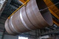 Moving pipes inside the workshop with an overhead crane using a traverse Royalty Free Stock Photo