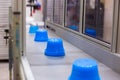 Pots on conveyor belt of plastic injection molding machine with robotic arm