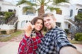 Moving and real estate concept - Happy young laughing cheerful couple man and woman holding their new home keys in front Royalty Free Stock Photo