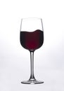 Moving red wine glass over a white background Royalty Free Stock Photo