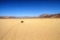 Moving rock on cracked desert ground