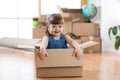 Moving to new apartment. Happy child in cardboard box. Royalty Free Stock Photo