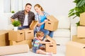 Moving to new home. Happy family with cardboard boxes Royalty Free Stock Photo