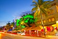 Moving traffic, Illuminated hotels and restaurants at sunset on Ocean Drive Royalty Free Stock Photo