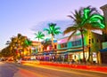 Moving traffic, Illuminated hotels and restaurants at sunset on Ocean Drive Royalty Free Stock Photo