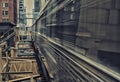 Moving Train on elevated tracks within buildings at the Loop, Glass and Steel bridge between buildings - Chicago City Center - Lon Royalty Free Stock Photo