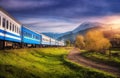 Moving train in mountains at sunset in autumn. Railway station Royalty Free Stock Photo