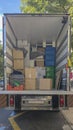 Moving truck loading goods at downtown street. Its equipped with lift ramp Royalty Free Stock Photo