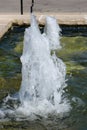 Moving water of two water fountains in a man made pond