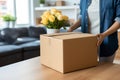 Moving in woman holds carton box in the new apartment