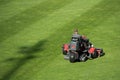 Mowing grass at the pitch of football stadium