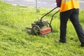 Mowing the lawn. The gardener mows the grass Royalty Free Stock Photo