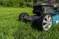 Mowing lawns, Lawn mower on green grass, mower grass equipment, mowing gardener care work tool, close up view, sunny day. Soft Royalty Free Stock Photo