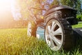 Mowing lawns, Lawn mower on green grass, mower grass equipment, mowing gardener care work tool, close up view, sunny day. Soft lig Royalty Free Stock Photo