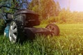 Mowing lawns, Lawn mower on green grass, mower grass equipment, mowing gardener care work tool, close up view, sunny day. Soft lig Royalty Free Stock Photo