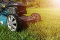 Mowing lawns, Lawn mower on green grass, mower grass equipment, mowing gardener care work tool, close up view, sunny day. Soft lig Royalty Free Stock Photo