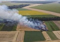 Mowing of straw burning in the field, burning of wheat residues, air pollution. Smoke in the field Royalty Free Stock Photo