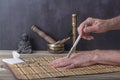 Moxibustion therapy - Traditional Chinese Medicine. Placement of the burning moxa stick on the hand. Royalty Free Stock Photo