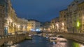 Moyka river timelapse in Saint Petersburg, Russia at night with a motion blurred touristic boat, illuminated old Royalty Free Stock Photo