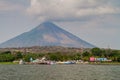 MOYOGALPA, NICARAGUA - MAY 1, 2016: View of Myogalpa village port at Ometepe island, Nicaragua. Volcano Concepcion in Royalty Free Stock Photo