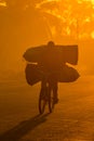 A Mozambican cyclist carrying large bags of coal to market