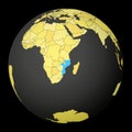 Mozambique on dark globe with yellow world map.